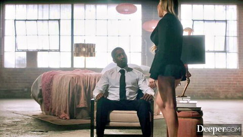 Blonde curvy woman in short skirt stands seductively over suited black man ready for interracial fuck