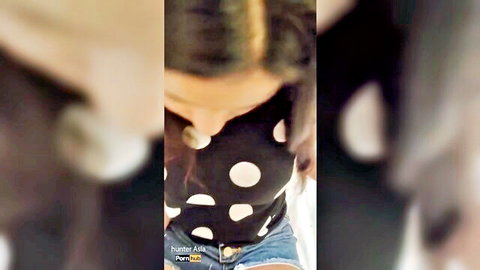 Sexy Asian teen in polka dot top showing deep cleavage and tiny denim shorts