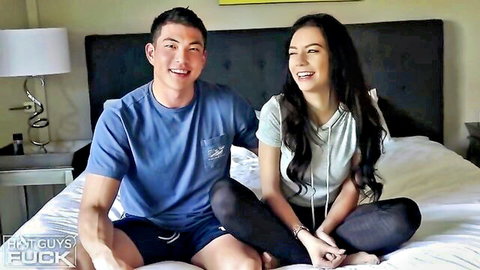 Rachel Ford smiles intimately with Asian stud Sean Lee on bed