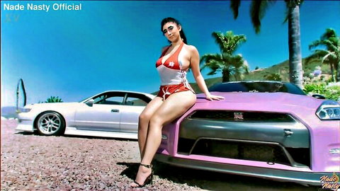 Busty babe in skimpy red bikini poses seductively on purple Nissan GT-R flaunting big tits