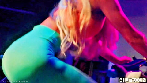 Reagan Foxx blonde MILF in tight green leggings on spin bike workout