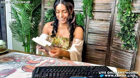 Brunette beauty smiling excitedly unboxing gift with teasing small tits cleavage on live cam