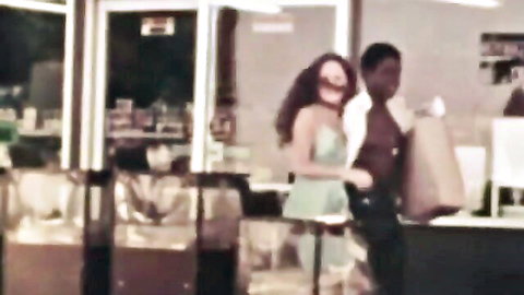 Vintage interracial couple, black man with shirtless woman in green dress