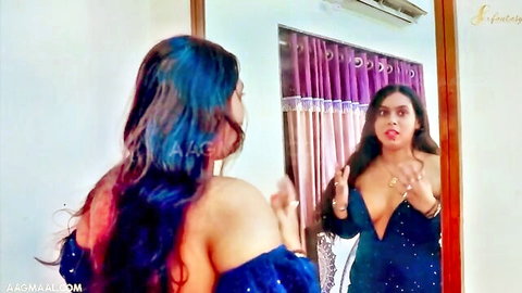 Sexy South Asian woman flaunting deep cleavage tits in sparkly low-cut dress mirror pose