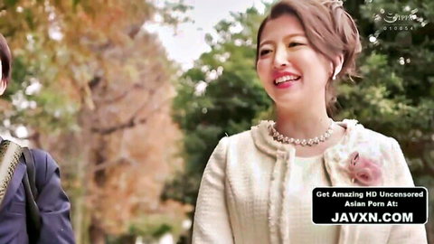 Elegant Japanese stepmom in cream outfit smiles with stepson outdoors