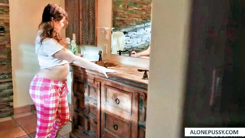 Pregnant Leana Lovings posing in bathroom with bulging belly in pink pajamas