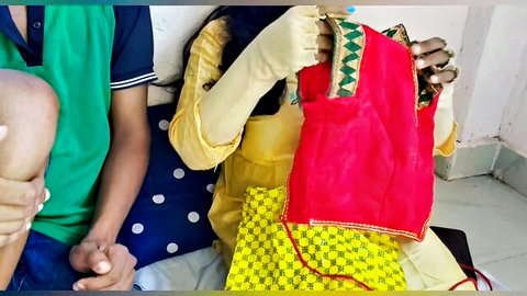 Desisarika in yellow Indian dress teasing with red cloth beside boyfriend