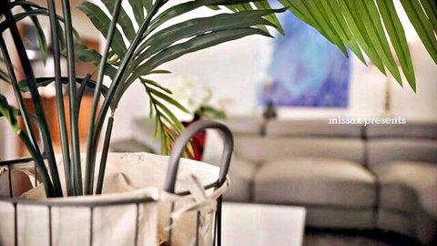 Cozy living room with green plant and sofa ready for taboo MILF stepdad fuck