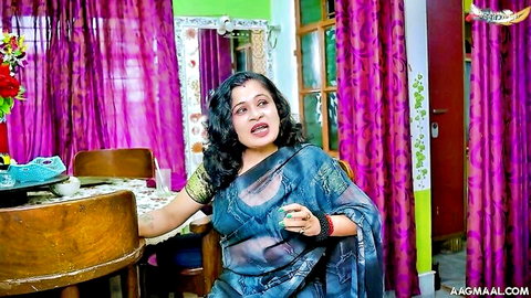 Shocked Indian MILF in sheer blue saree sitting at table exposing curves