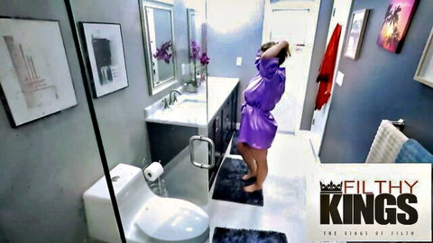 Busty blonde in sheer purple robe teases in modern bathroom, POV shower tease