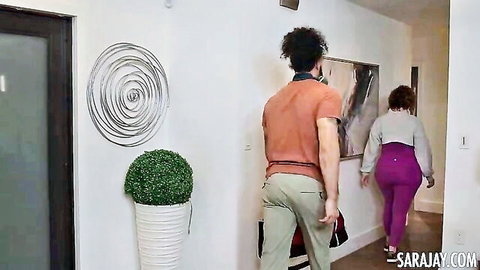 Curvy redhead MILF big ass in tight purple leggings walking ahead as guy follows