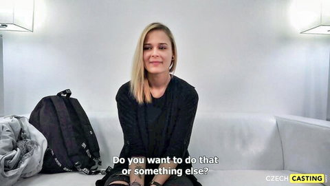 Blonde Czech teen smiling in casual black top during casting interview