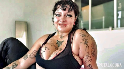 Busty tattooed babe with huge tits in sheer mesh top posing seductively