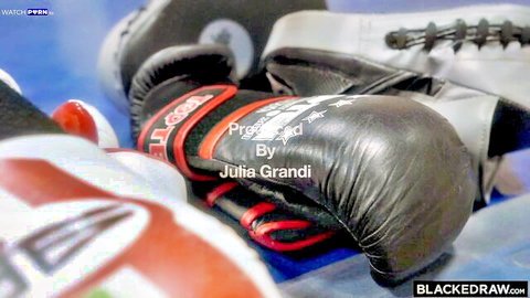 Closeup of red black boxing gloves produced by Julia Grandi for BlackedRaw interracial porn gym scene