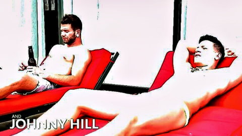 Two shirtless athletic gay hunks lounge poolside in speedos holding beers