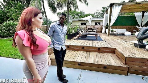 Curvy redhead MILF with huge tits in tight pink dress flirts with black stud poolside