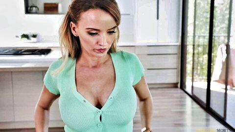 Natasha Nice in low-cut green blouse showing deep cleavage