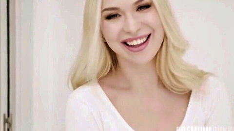 Smiling blonde babe teases deep cleavage in tight white v-neck top