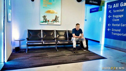 Man sits legs apart in public airport terminal lounge eyeing beach poster before fucking