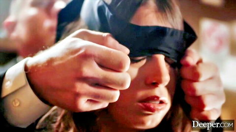 Blindfolded woman's mouth forced open by rough male hands in intense face grip