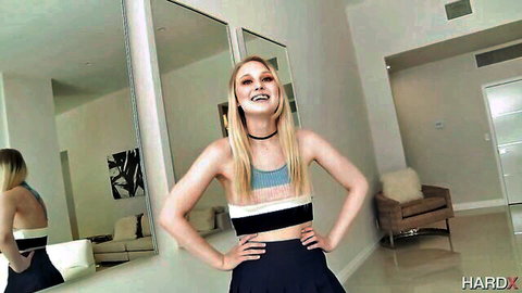 Lily Rader posing confidently in striped crop top and black skirt