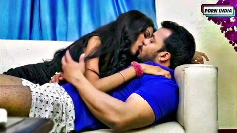 Passionate Indian couple kissing intimately on couch, step-sis theme