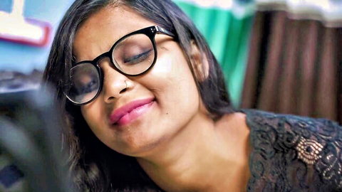 Sexy Indian teen girl in glasses and lace top smiling seductively closeup