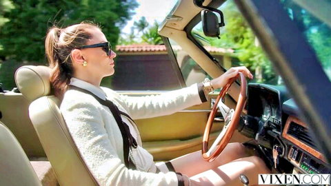 Brunette babe in white blazer and tie driving convertible with thighs teasingly spread