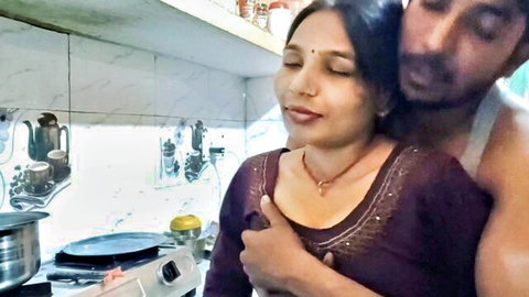 Young Indian couple embracing intimately in kitchen before sex