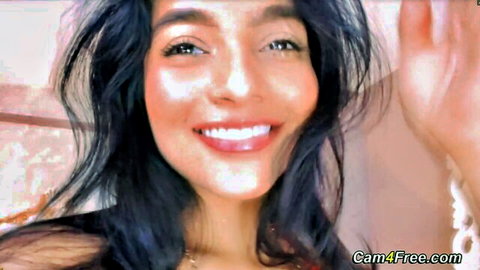 Sexy smiling Latina babe waving on live webcam with glossy lips