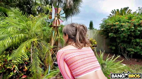 Tommy King in pink mesh top, teasing backside in garden outdoor scene