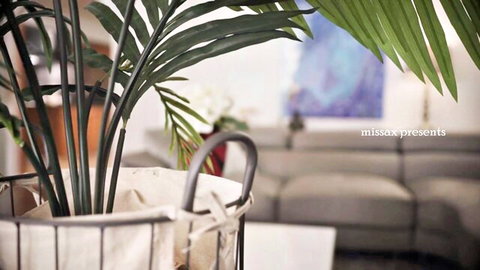 Kenzie Taylor in cozy living room with plants and blue art