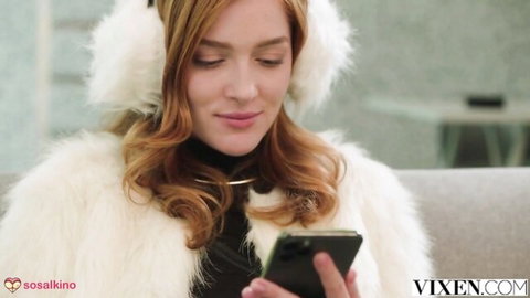 Jia Lissa redhead in white fur coat and earmuffs, gazing at phone seductively