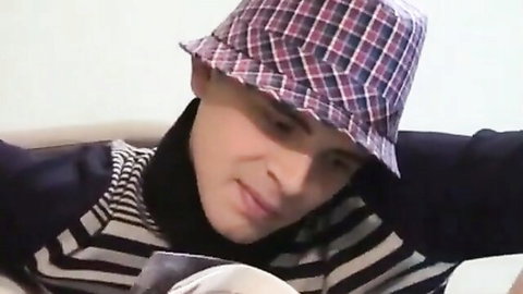 Handsome young gay twink in checkered bucket hat and striped turtleneck gazing seductively