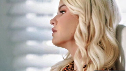 Slimthick Vic blonde with curly hair in seductive side profile pose