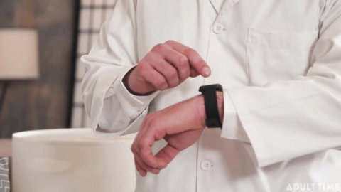 Doctor in white lab coat adjusts smartwatch on wrist in clinic