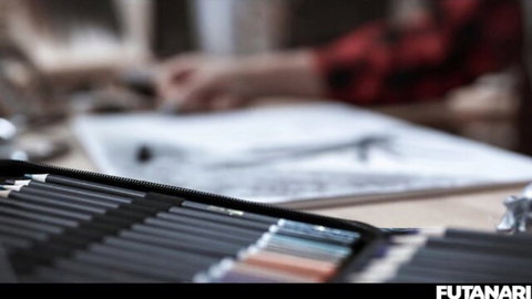 Artist's hand sketching futanari hentai art with colored pencils on paper close-up