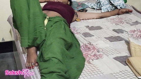 Sexy Indian Sangeeta Bai lying seductively on bed in green salwar spreading legs teasing