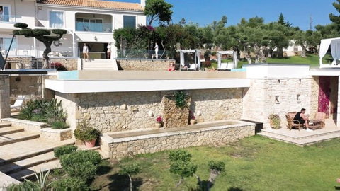 Jia Lissa lounging seductively by luxury pool in Hotel Vixen