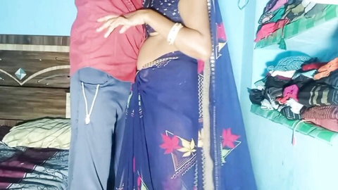 Indian Bhabhi in blue saree passionately embraced from behind in village setting