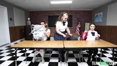 Three sexy teen schoolgirls in plaid skirts knee socks posing in classroom