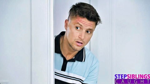 Surprised stepbrother peeks from door with forehead scratch in stepsiblings caught scene