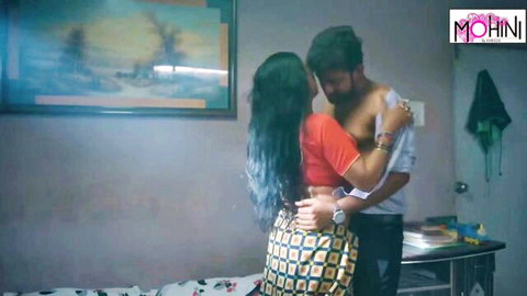 Sexy Indian babe in red blouse and skirt passionately embraced from behind by bearded guy