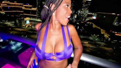 Raven Swallowz in purple strappy lingerie, smiling on Vegas rooftop