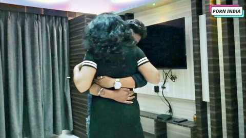 Indian couple passionately hugging from behind in steamy hotel room
