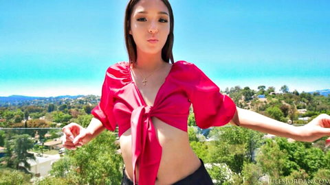 Layla Jenner posing in red crop top outdoors, sexy neighbor daughter vibe