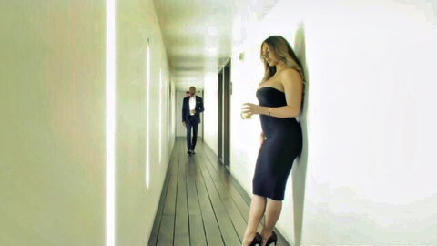 Busty blonde Kayley Gunner in tight black dress looks back at black man in suit
