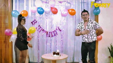 Busty Indian brunette in sexy black dress poses at birthday party with muscular hunk
