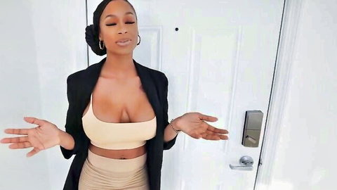 Skyla Novea ebony beauty in low-cut tank top and blazer showing deep cleavage