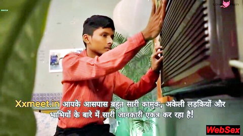 Young Indian teen boy in red shirt smiling seductively by barred window ready to fuck